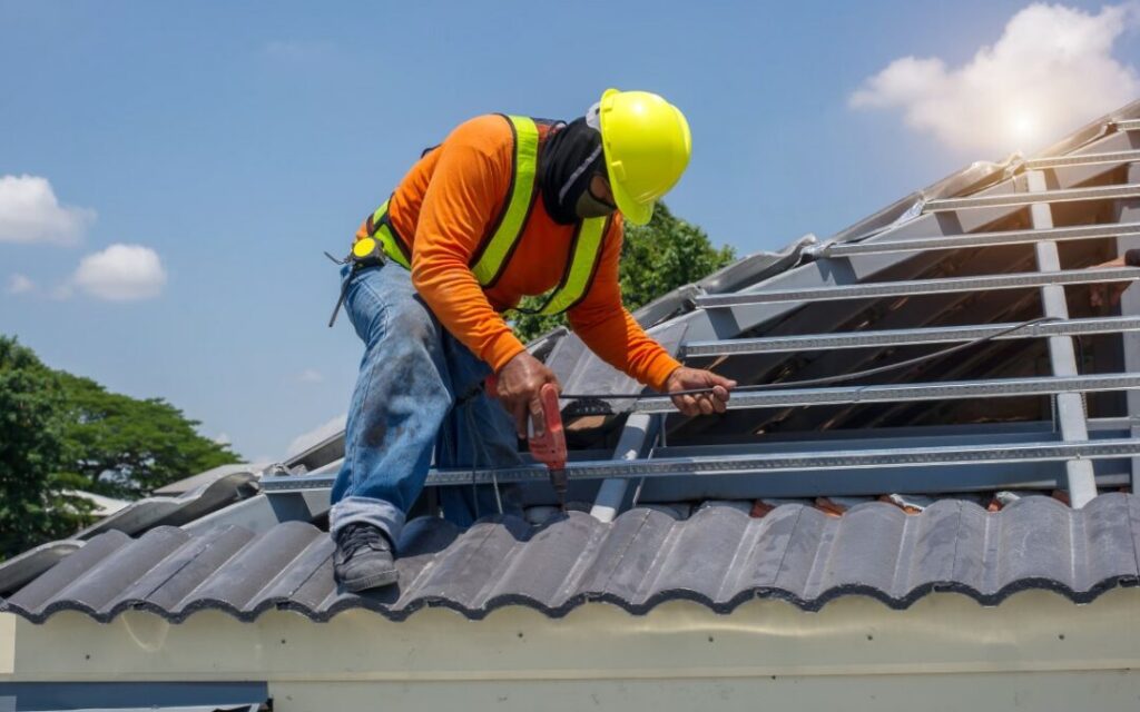 Homeowner reviewing roof replacement cost breakdown with roofing expert