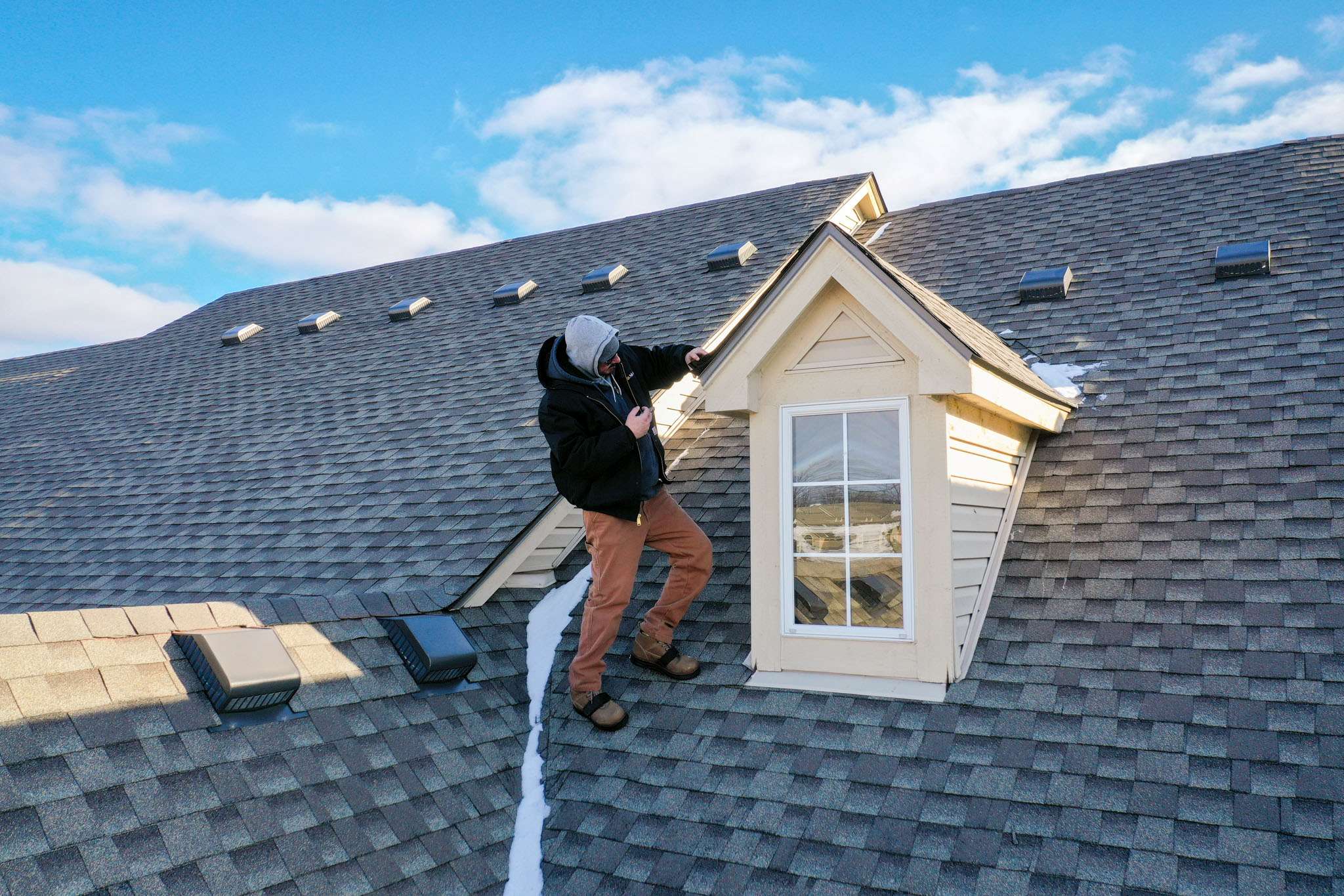 residential roof repair contractor inspecting