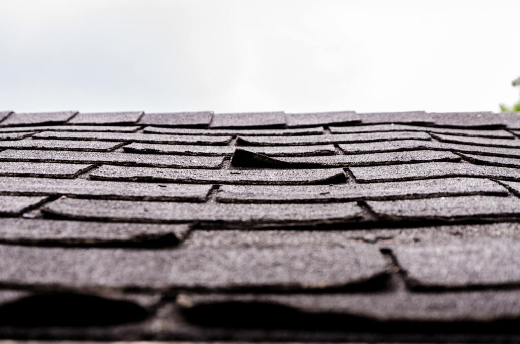 Missing, curled, or cracked asphalt shingles
