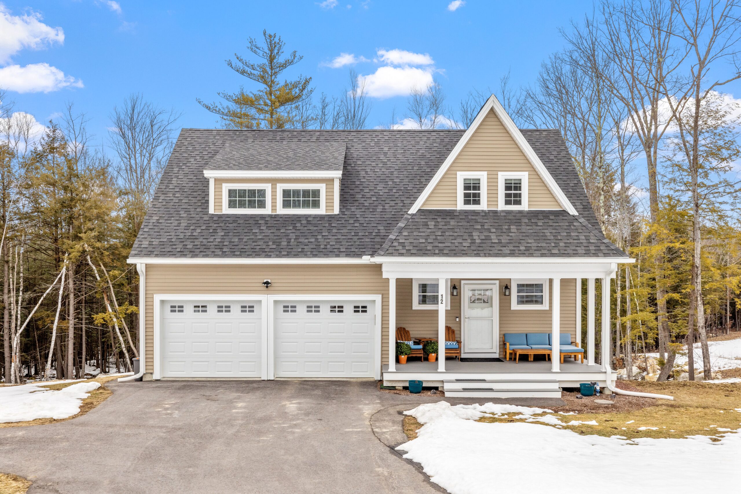 An aerial view of an asphalt shingle roof on a two-story house.