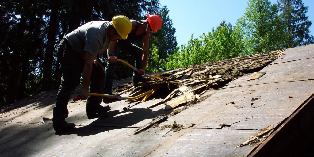 Jobsite photo of rotted plywood decking exposed during tear-off