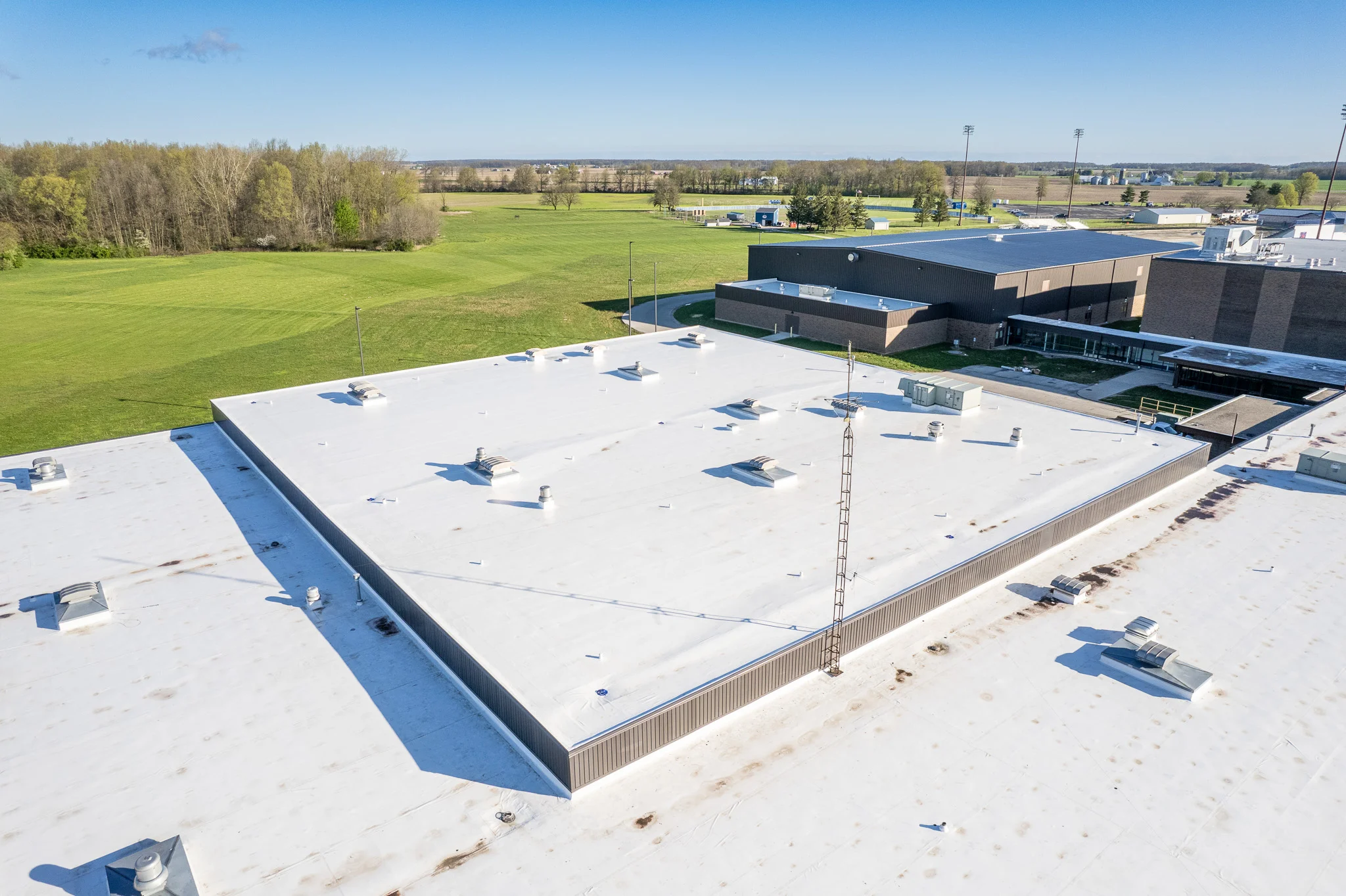 Wide aerial or close-up photo of a commercial TPO EPDM flat roof