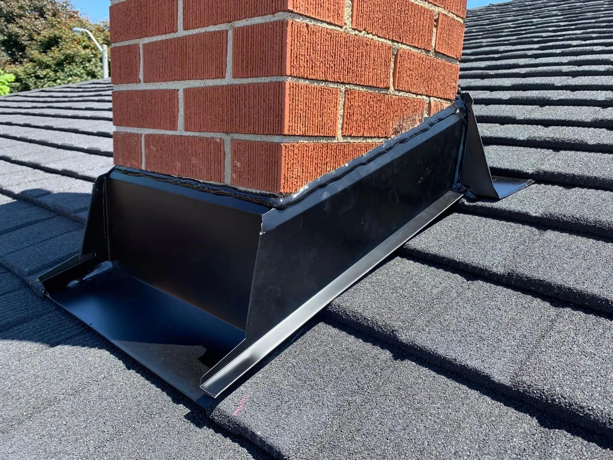 Brick chimney with new step and counter flashing on a Hudson, MA home